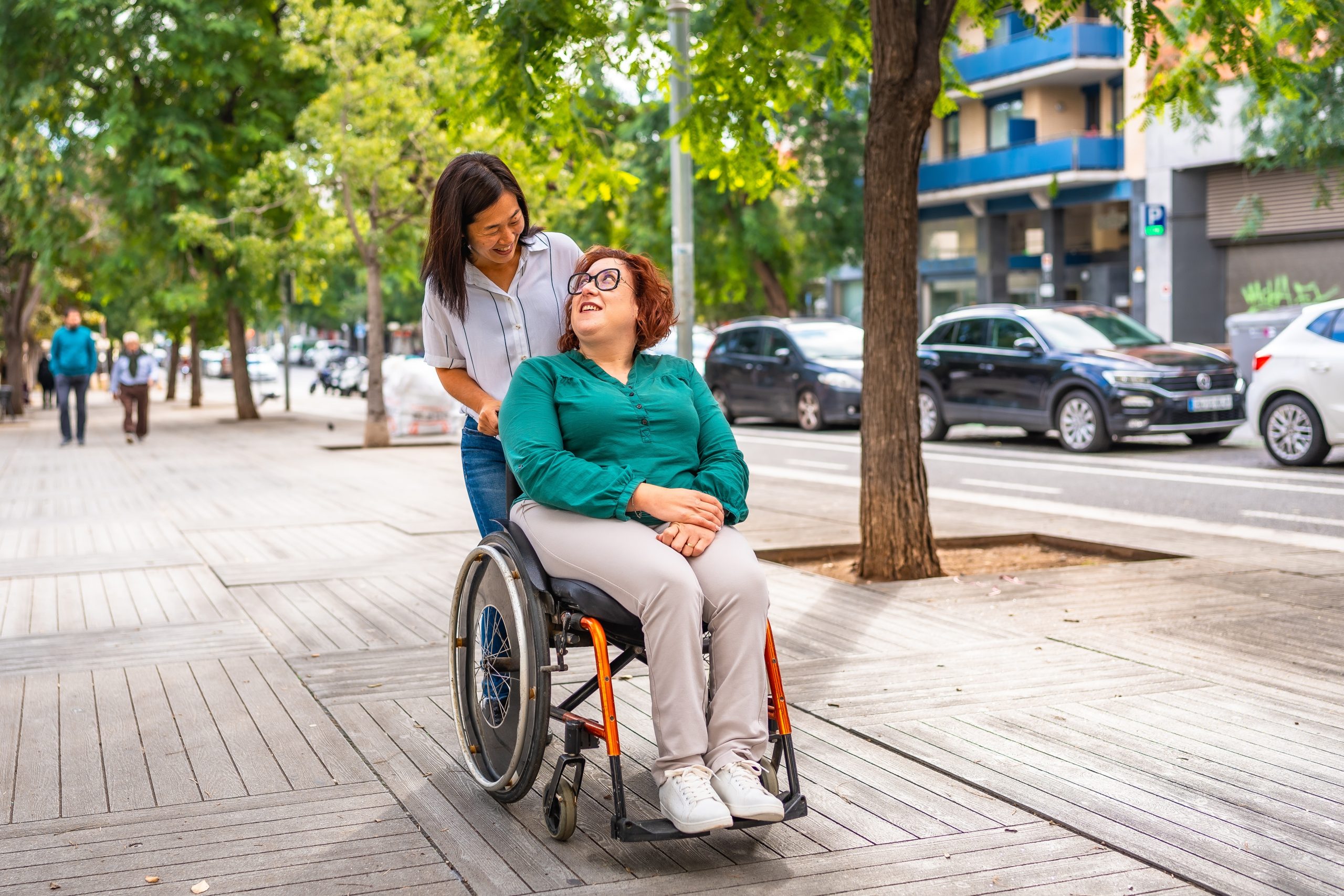 Asian,Woman,Pushing,The,Wheelchair,Of,A,Friend,With,Disability